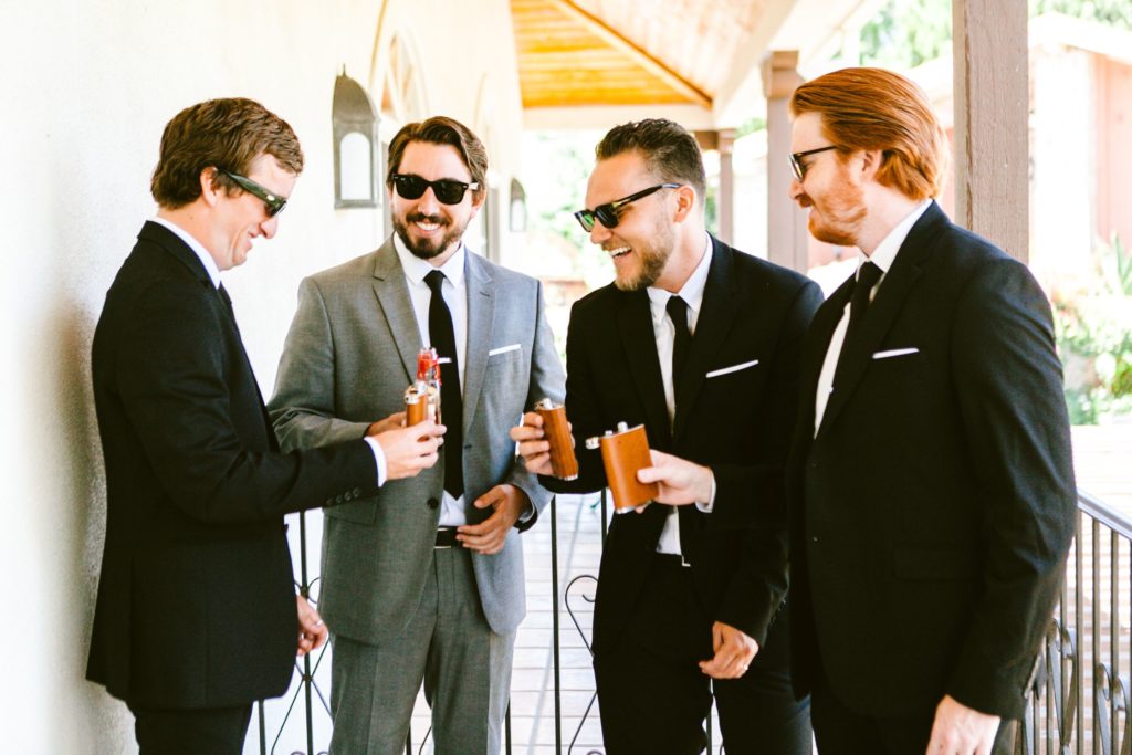 Groom and groomsmen drinking whiskey