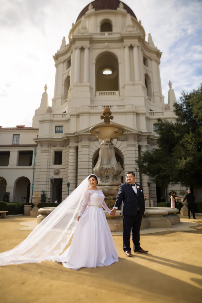 pasadena city hall bride and groom posing fountain