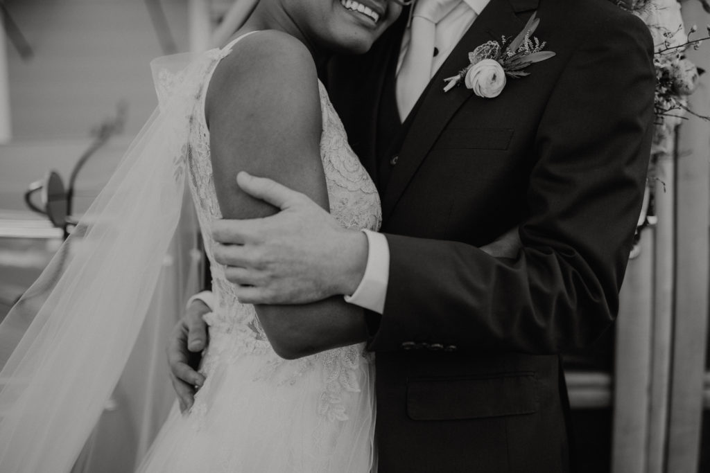 Black and White photo of Bride and Groom Embracing